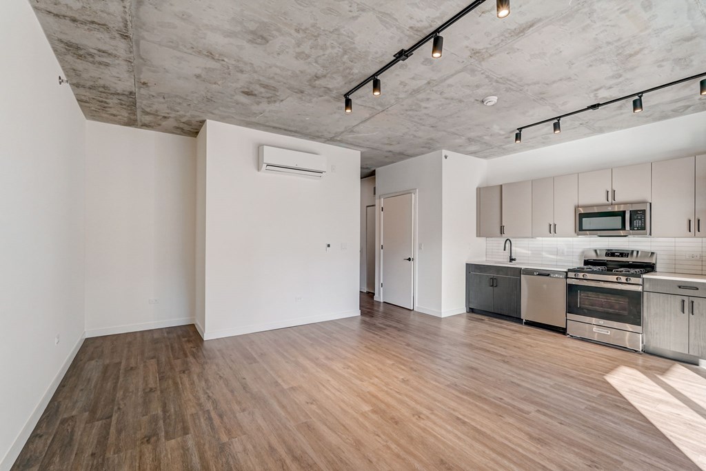 A kitchen with a stove top oven and microwave.