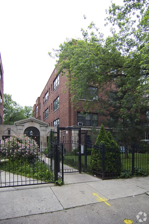 a building with a fence and a gate in front of it