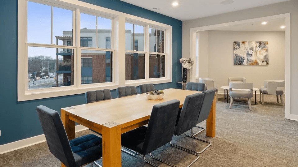 A conference room with a long table and chairs.