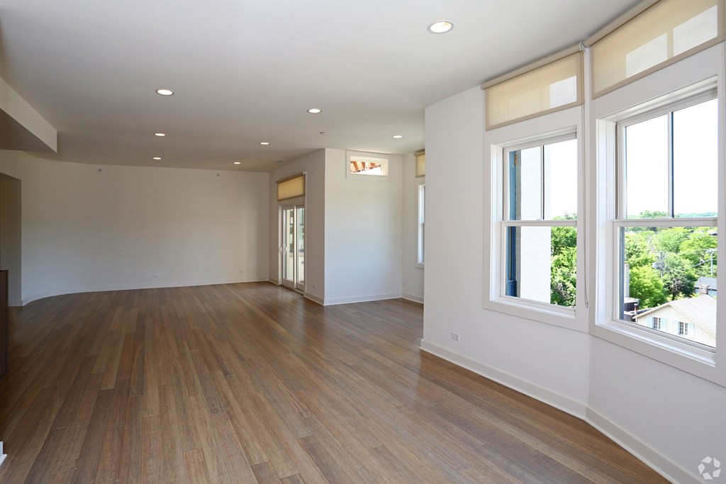 A room with wooden floors and white walls.