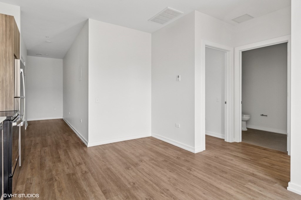 A room with wooden floors and white walls.