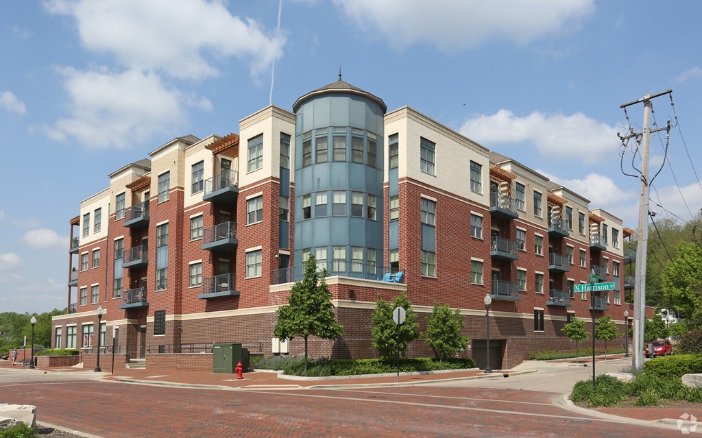 A large apartment building with a mix of brick and glass exterior.