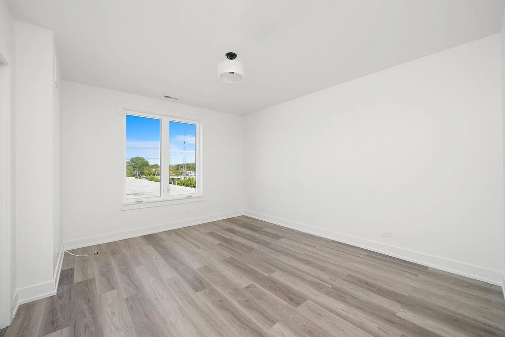 A room with a window showing a street view.