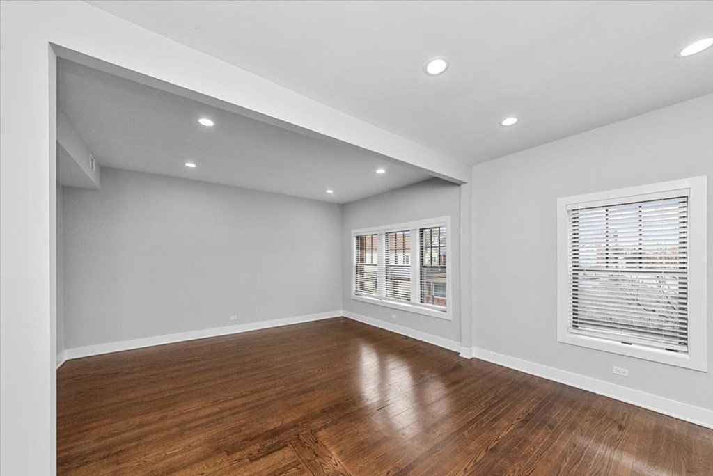 A room with wooden floors and white walls.