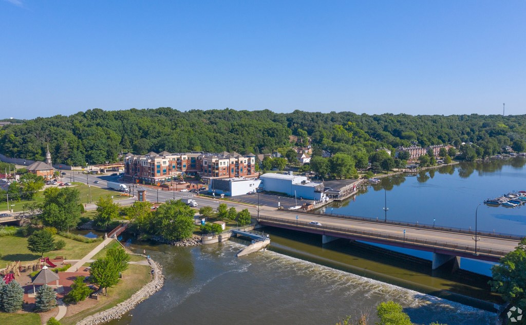 A river flows through a city with a bridge crossing over it.