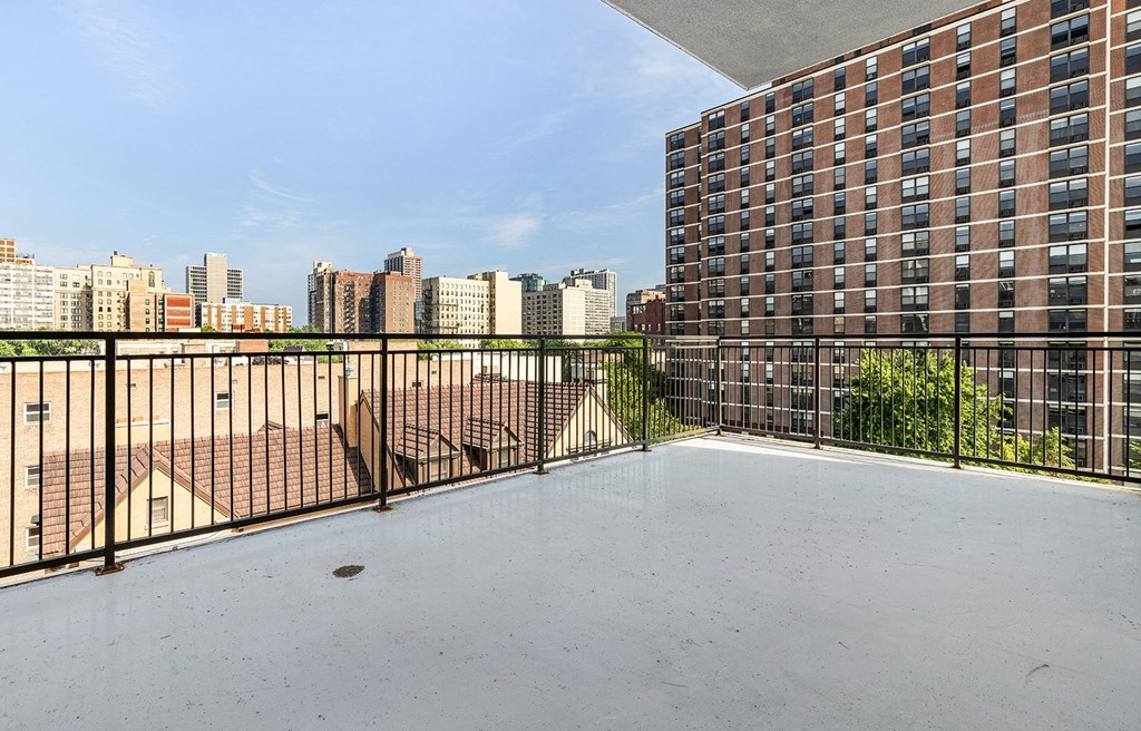 the balcony has a view of the city and the pool