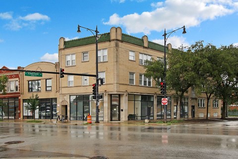 a large building on the corner of a street with traffic lights