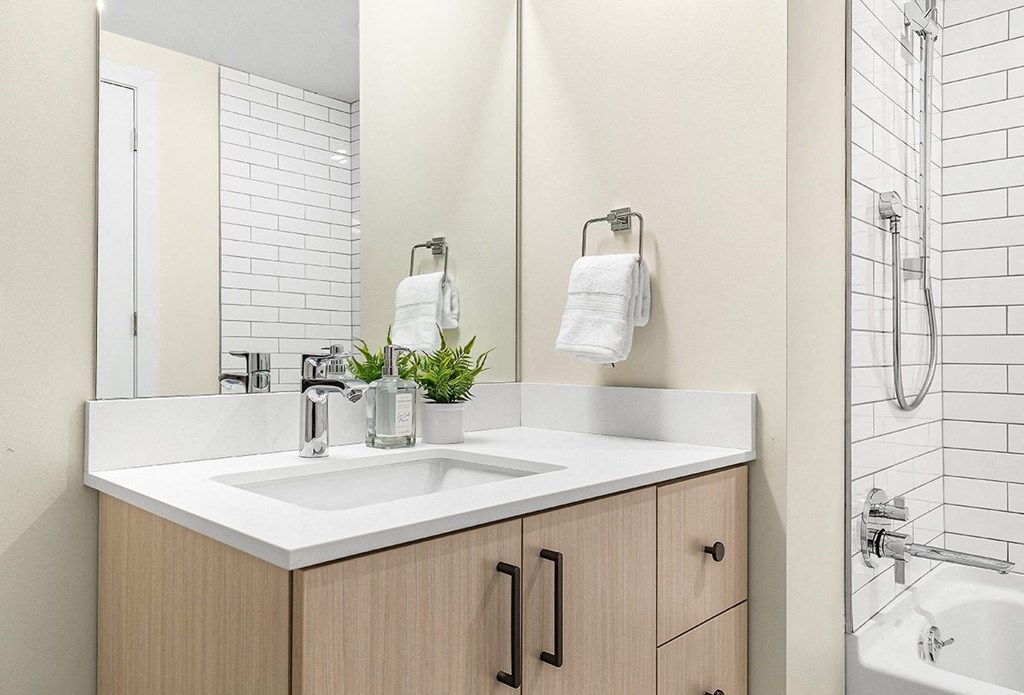 the residence on lamar apartment homes bathroom with sink and shower