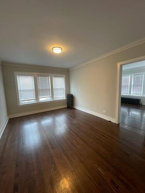 an empty living room with a hard wood floor