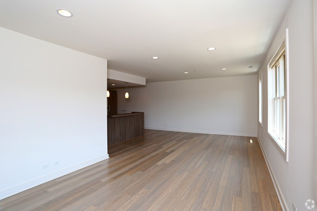 A room with wooden floors and white walls.