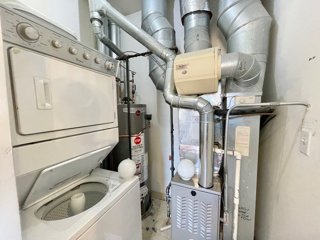 the washing machine and dryer are in the corner of a room