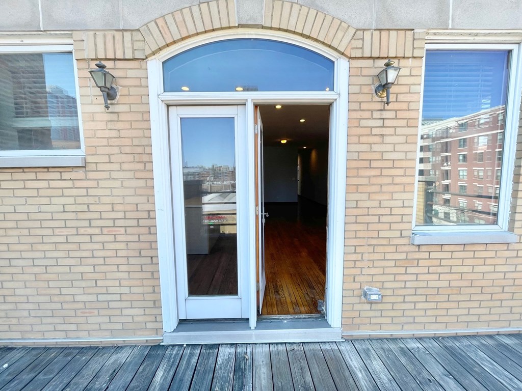 the entrance to a brick building with an open door
