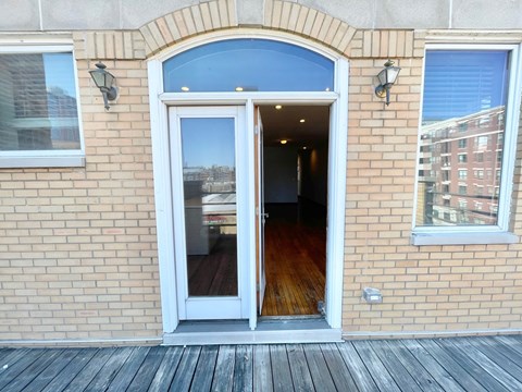 the entrance to a brick building with an open door