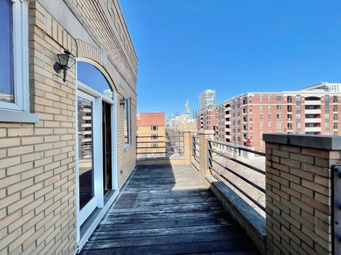 the deck of a balcony with a view of the city