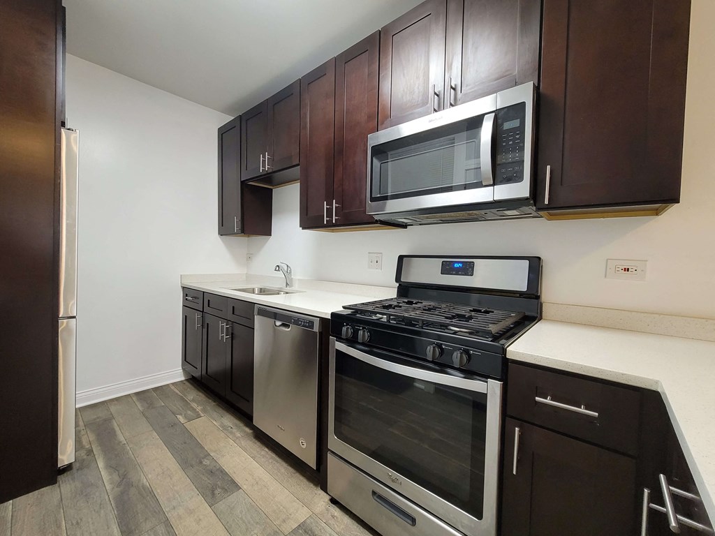 a kitchen with stainless steel appliances and wooden cabinets