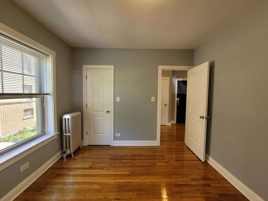 a living room with wood floors and a large window