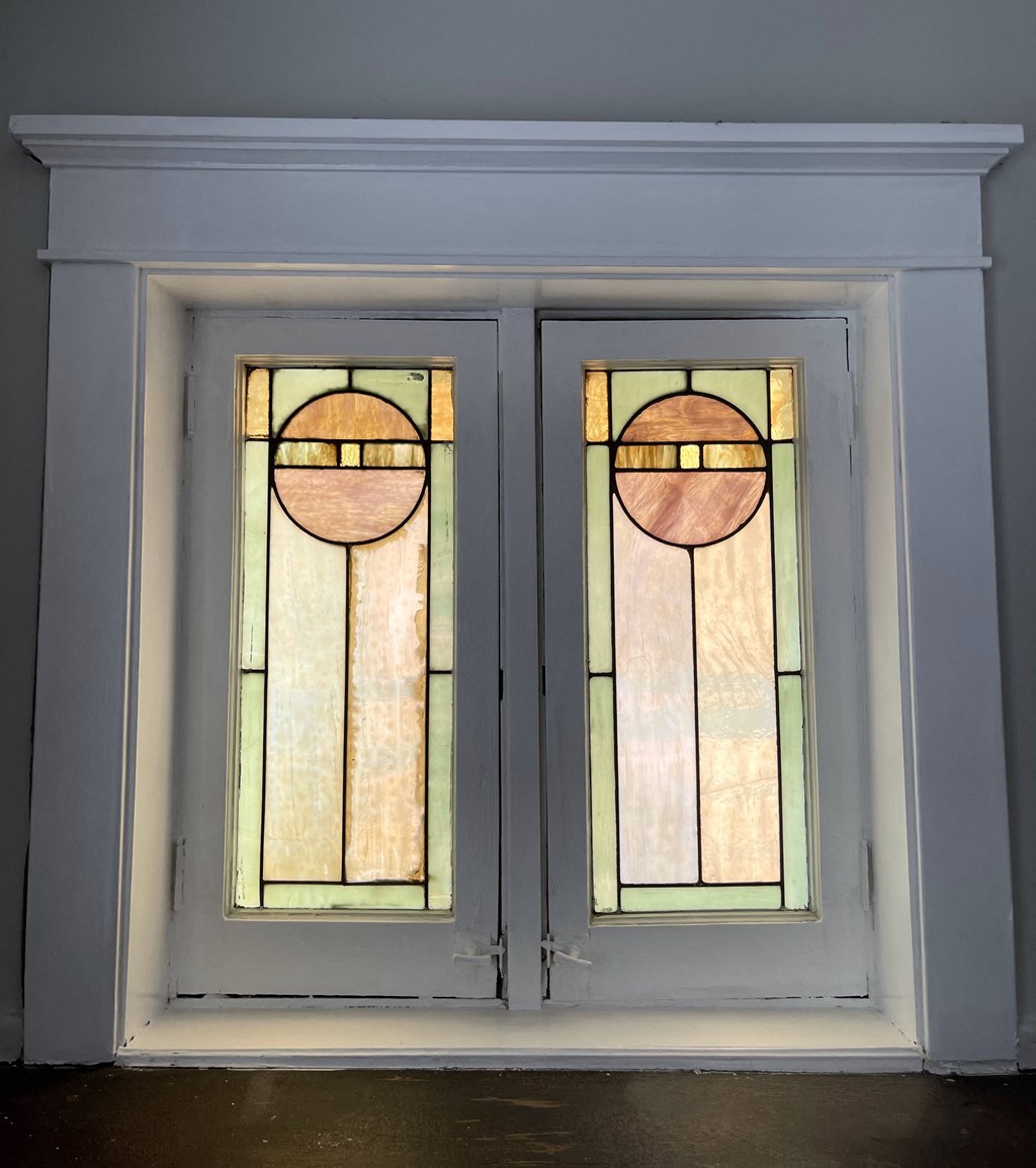 a pair of windows with rainbow colored stained glass
