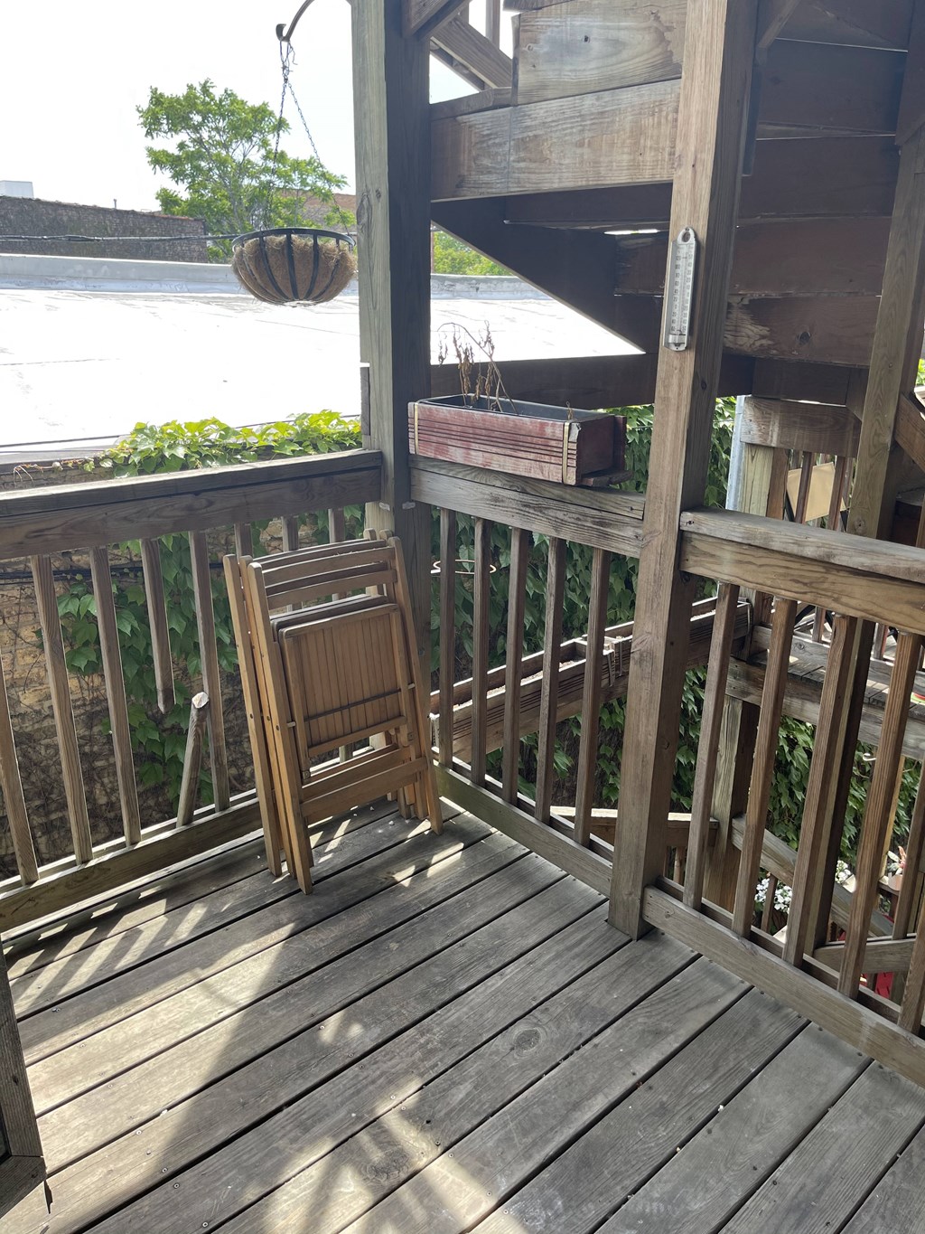 a deck with a chair and a box on it