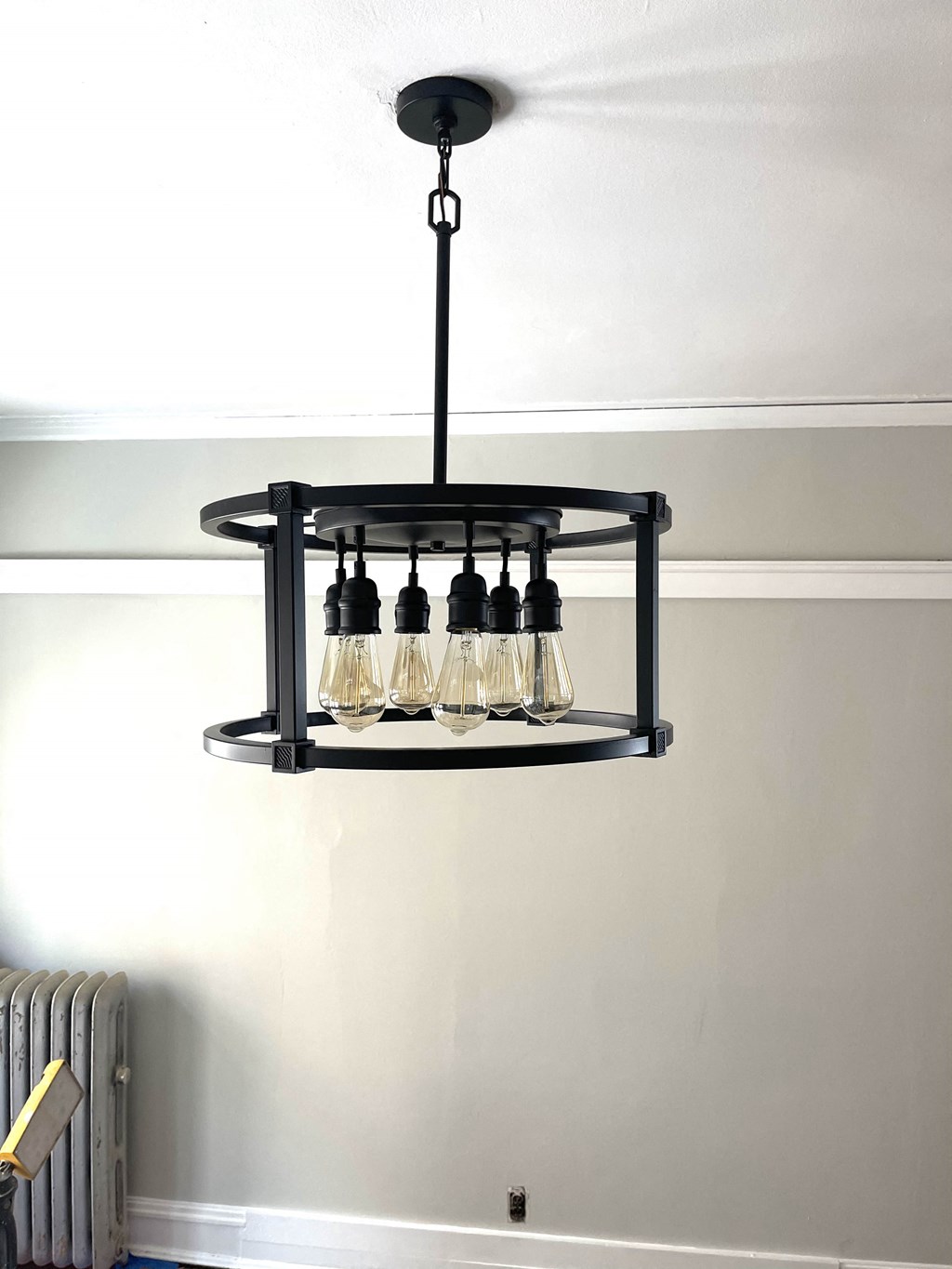 a close up of a black chandelier with wine glasses