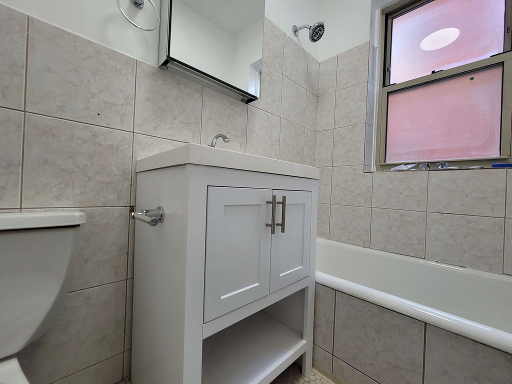 a bathroom with a sink and a toilet and a bath tub