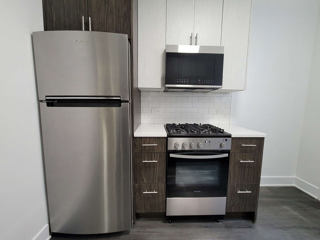 a kitchen with stainless steel appliances and a refrigerator