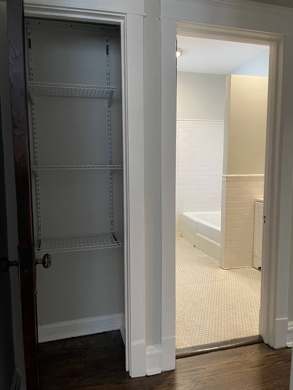 a view of a bathroom with an open closet door