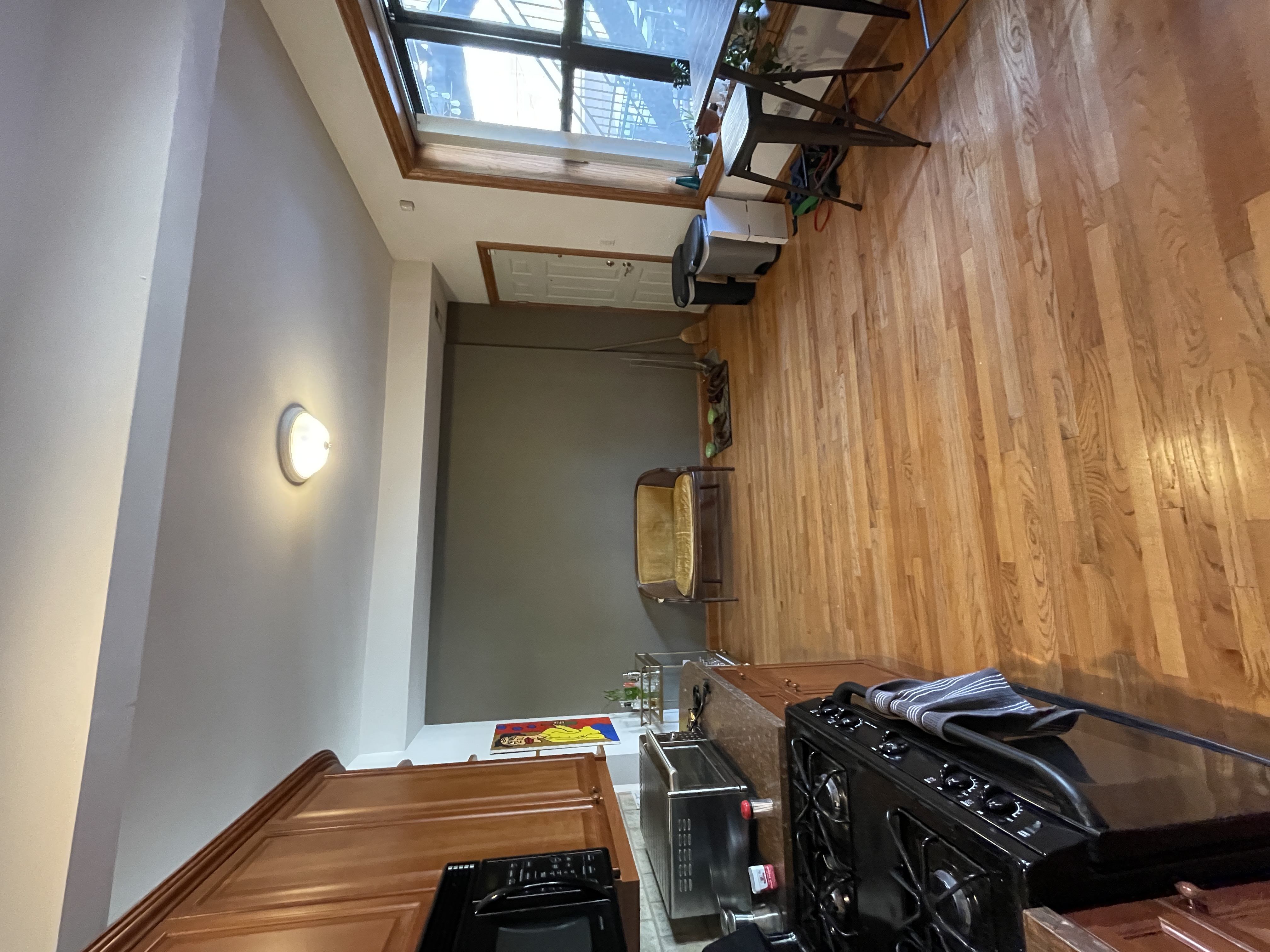 A kitchen with wooden cabinets and a black stove top oven.