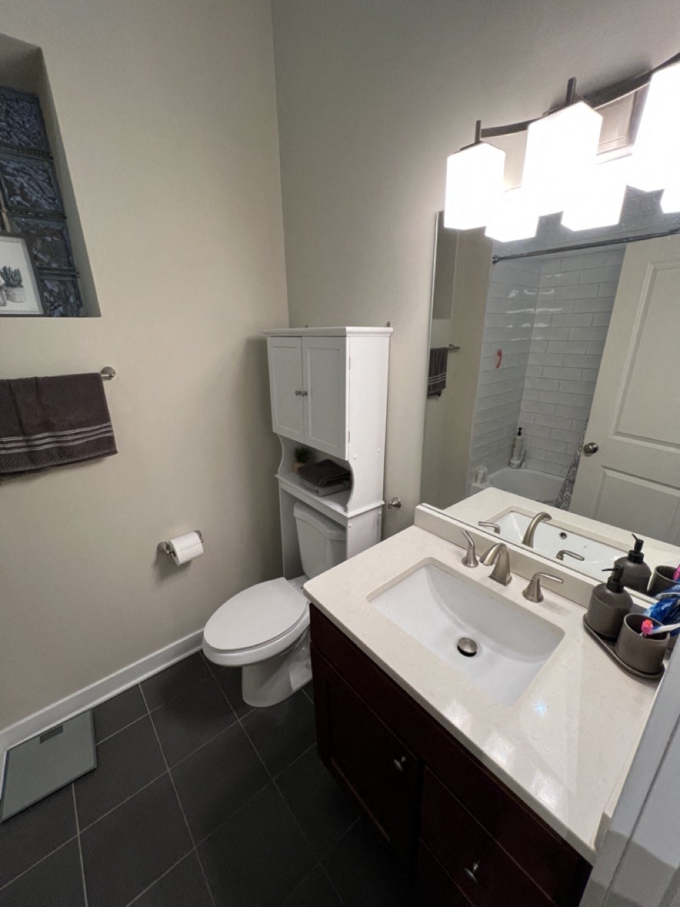 a small bathroom with a sink toilet and mirror