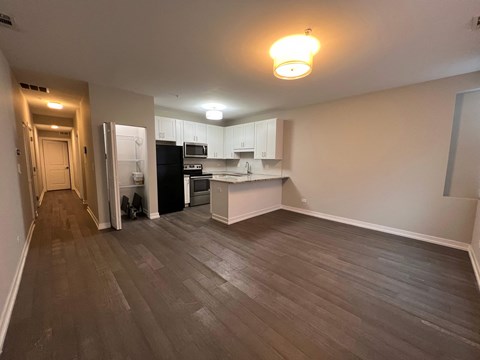A kitchen with a black refrigerator and a black oven.