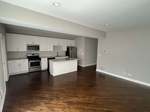 a kitchen and living room in a 555 waverly unit