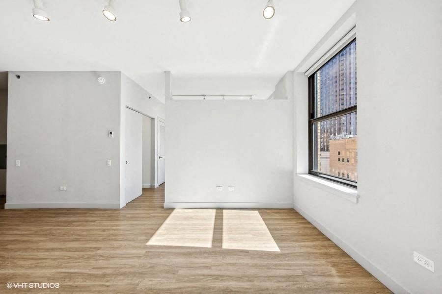 an empty room with white walls and a window