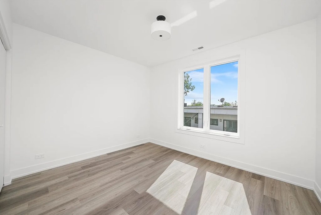 A room with a window and a white ceiling.