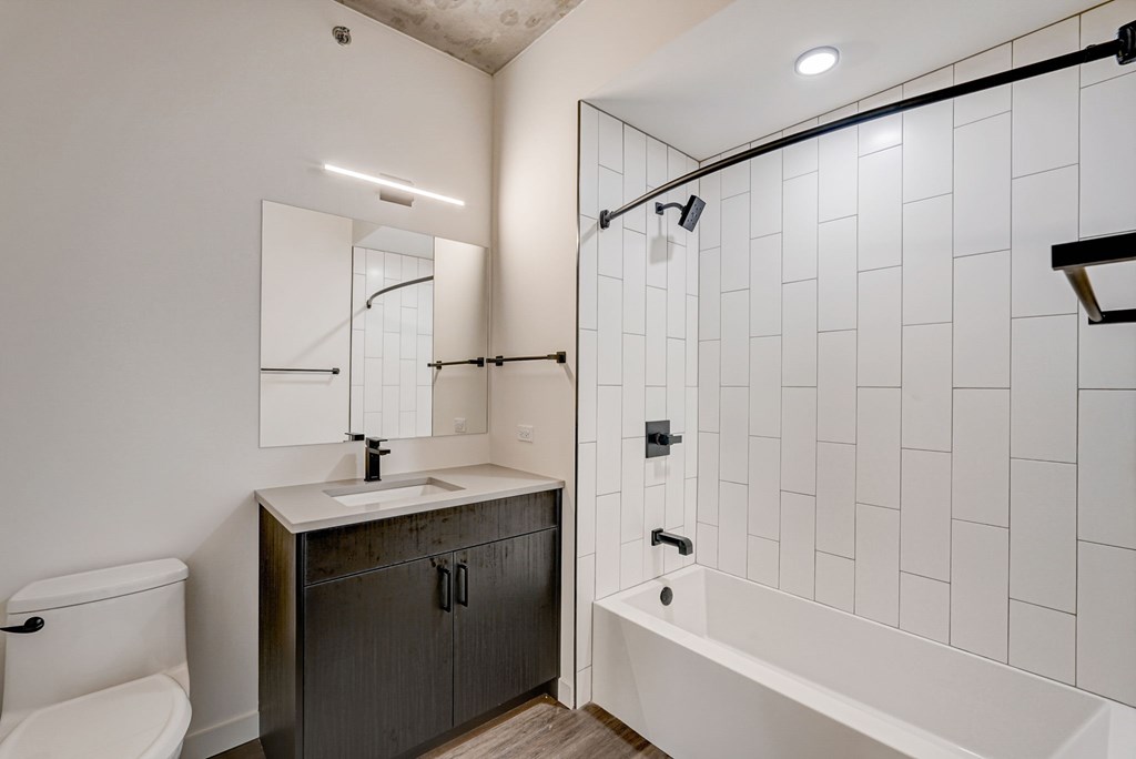 A white bathroom with a sink, toilet, and bathtub.