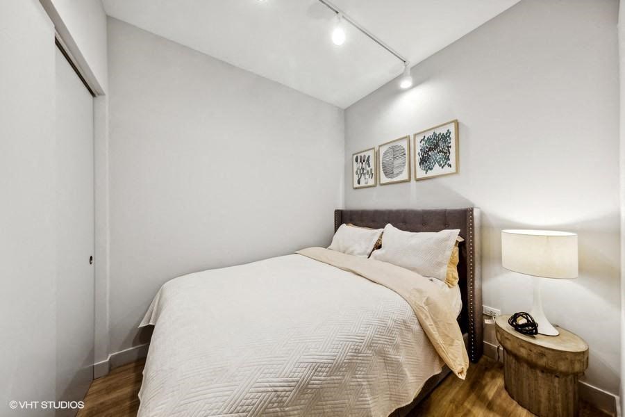 a bedroom with a bed and a night stand