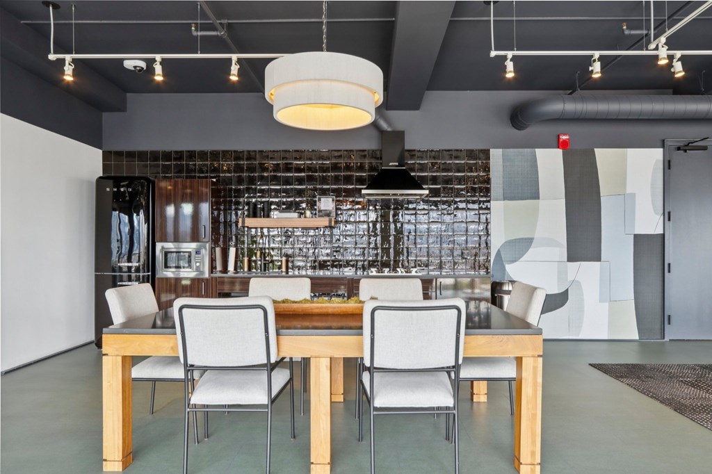 A modern dining room with a wooden table and chairs.