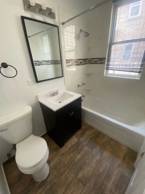 a bathroom with a white toilet and a sink