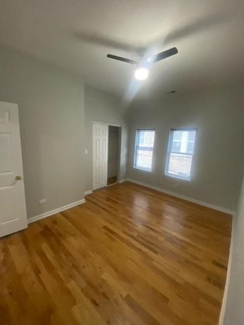 a living room with a hard wood floor and a ceiling fan