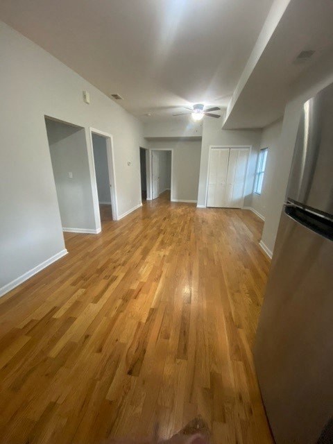 an empty living room with a wood floor