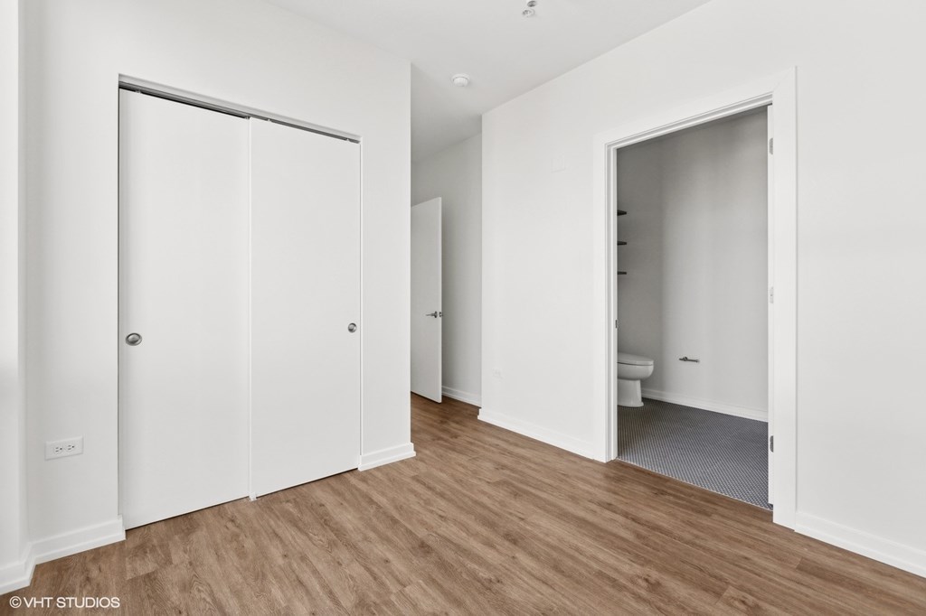 A white room with a toilet in the corner.