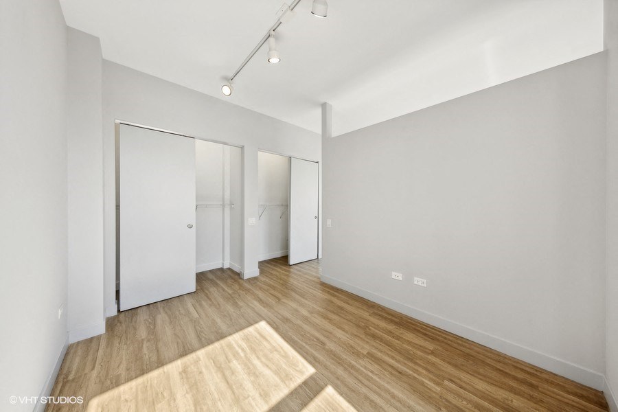 an empty living room with white walls and wood floors