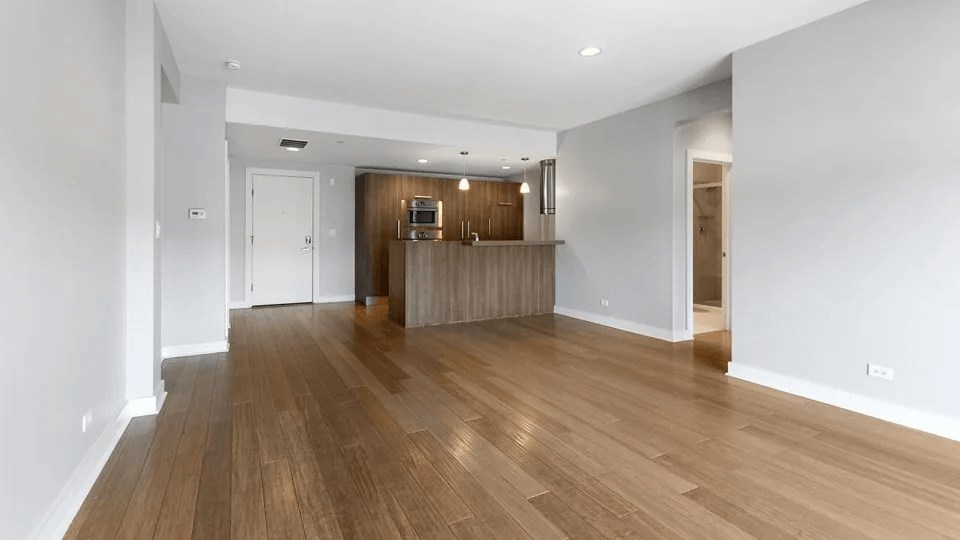 A room with wooden floors and white walls.