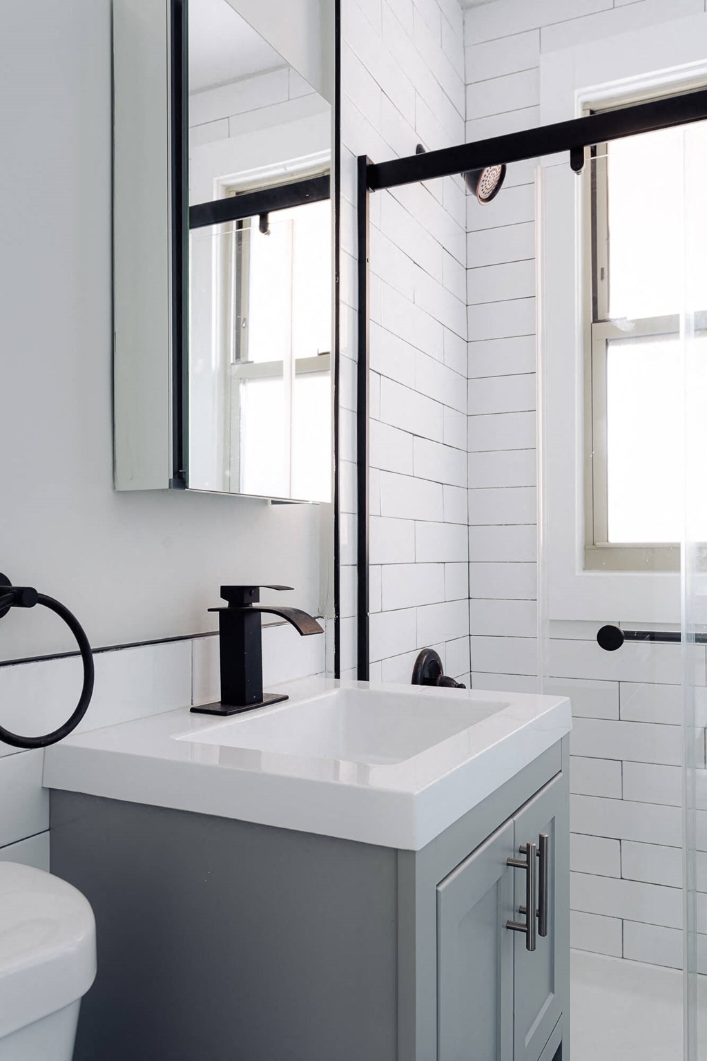 a white bathroom with a sink and a mirror
