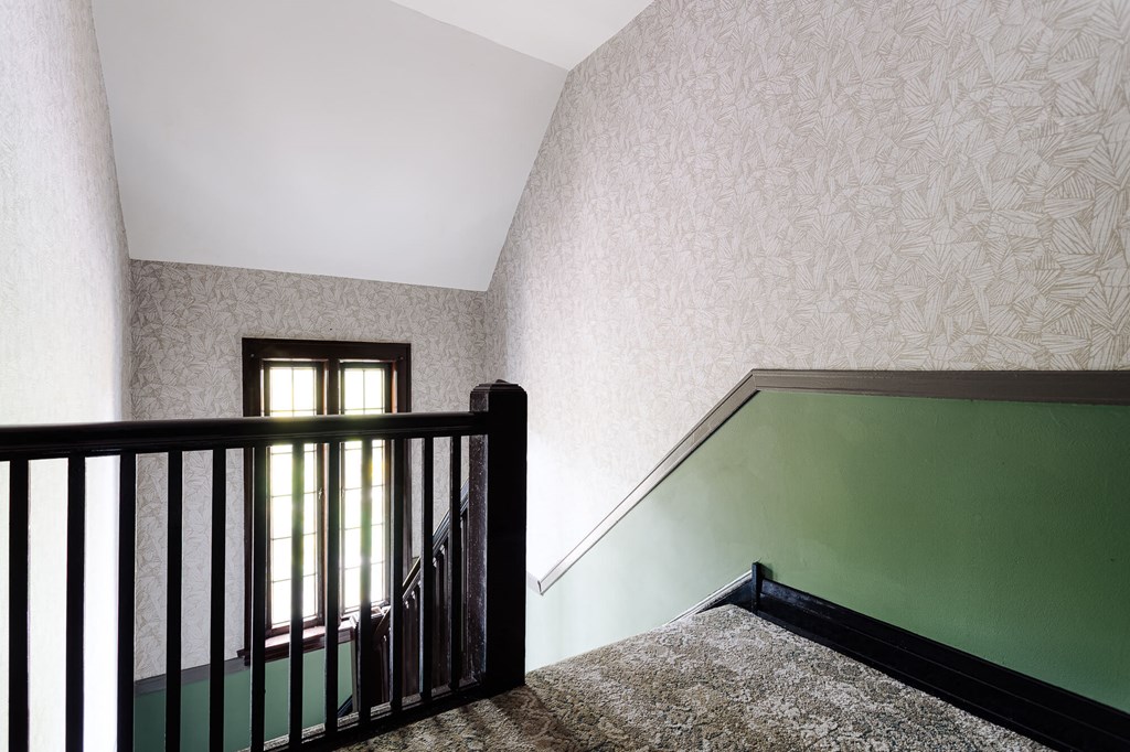 a view of a stairwell with a railing and a window