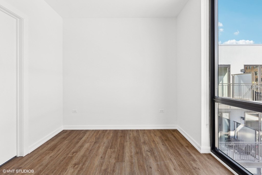 A room with wooden floors and white walls.
