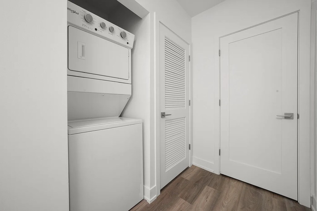 A white oven and washing machine in a small room.