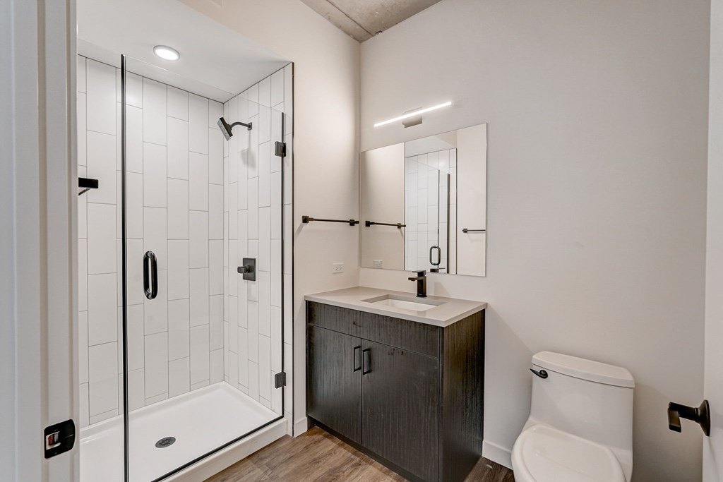 A white toilet sits next to a sink in a bathroom.