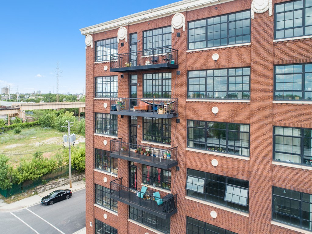 a large brick building with many windows and fire escapes
