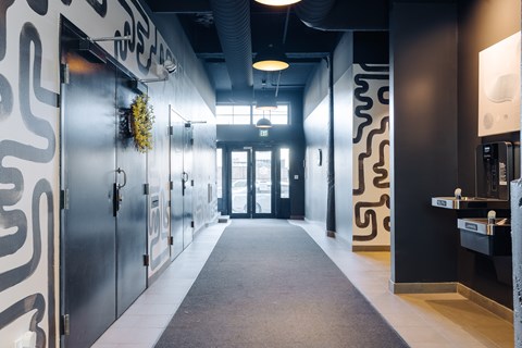 A hallway with a black and white design on the walls.