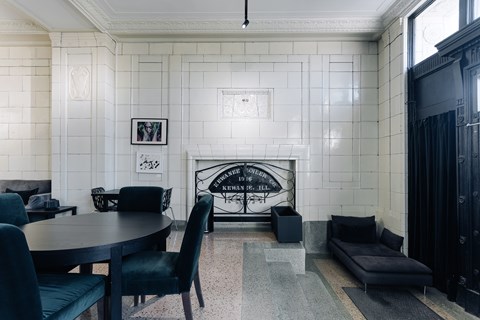 A black and white living room with a fireplace and a sofa.