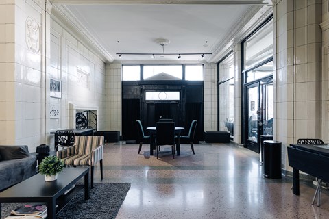 A black and white living room with a pool table.